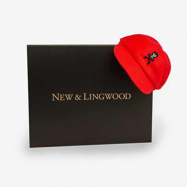 red hat with skull and cross bones on packaging box – New & Lingwood – point one percent 