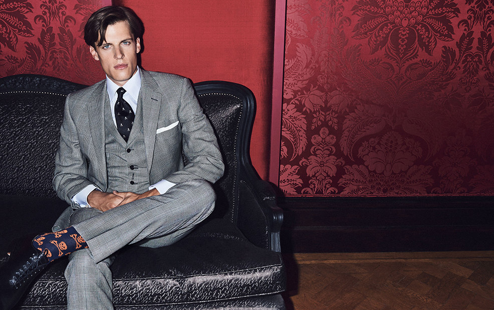 fashion man in gray suit wearing skull and cross bone socks – New & Lingwood – point one percent