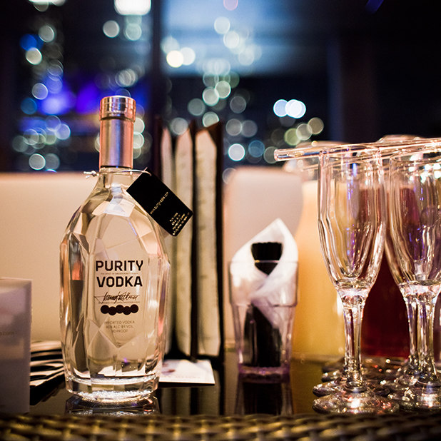 assortment of flutes and bottle of vodka – Purity Vodka – point one percent