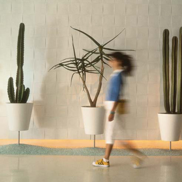 blurred woman walking in lobby with cacti – The Standard – point one percent