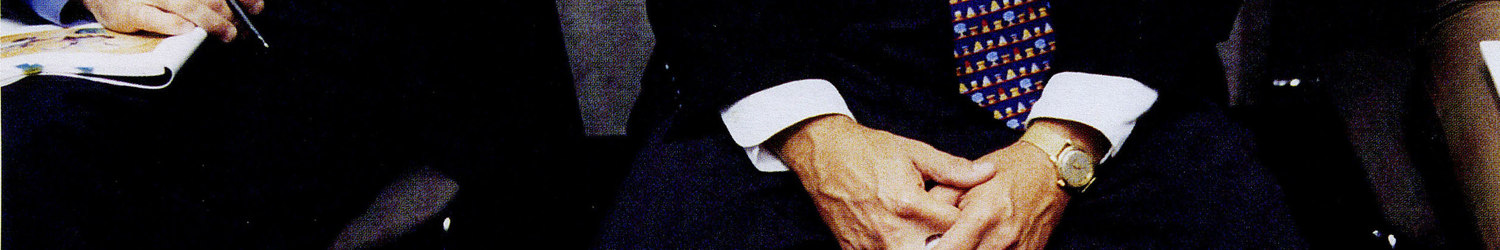 man in suit with auction paddle – Christie’s – Point One Percent