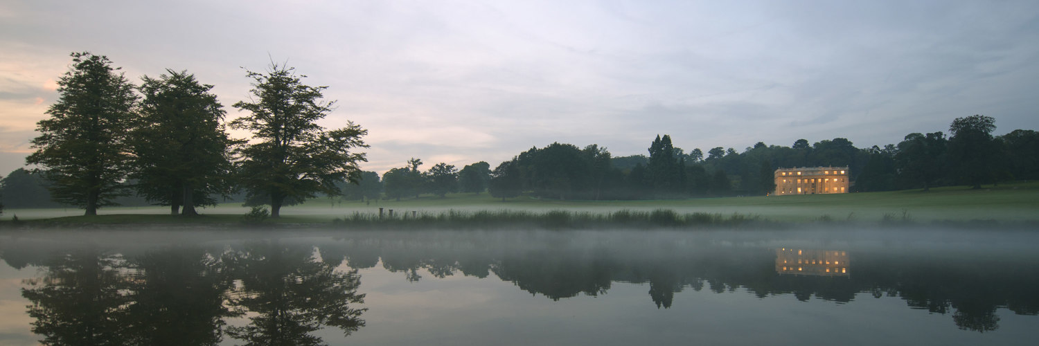 mansion on a lake at dusk – Savills – point one percent