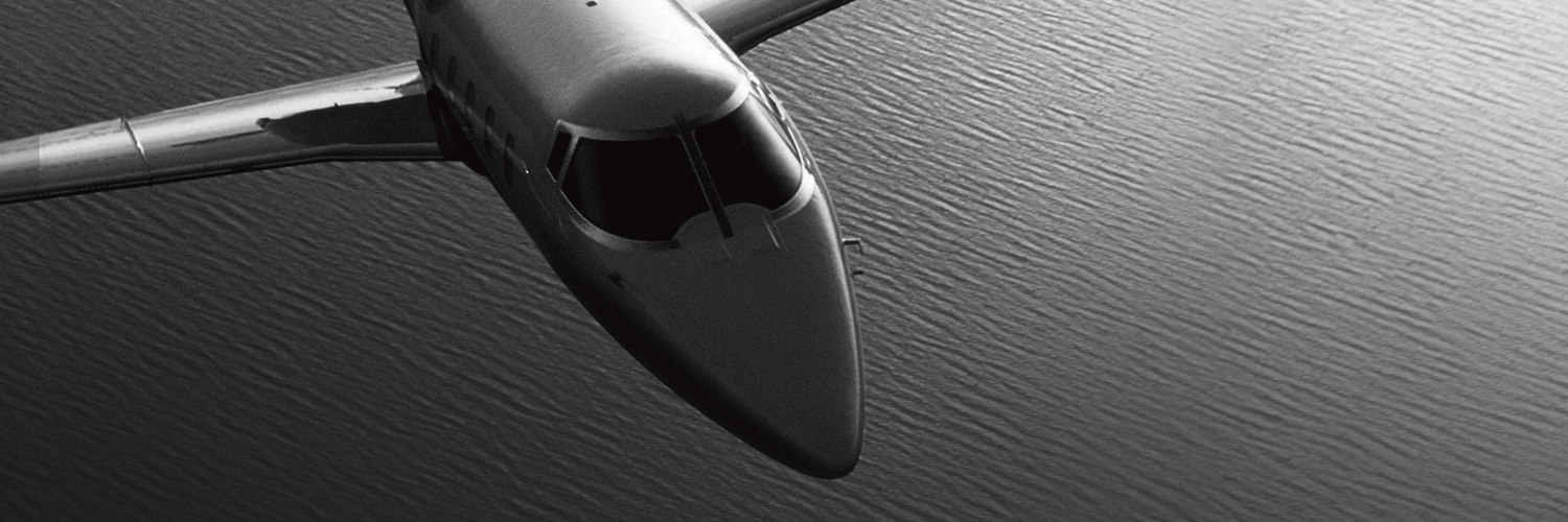 Black and white private plane over water – Flexjet – Point one percent